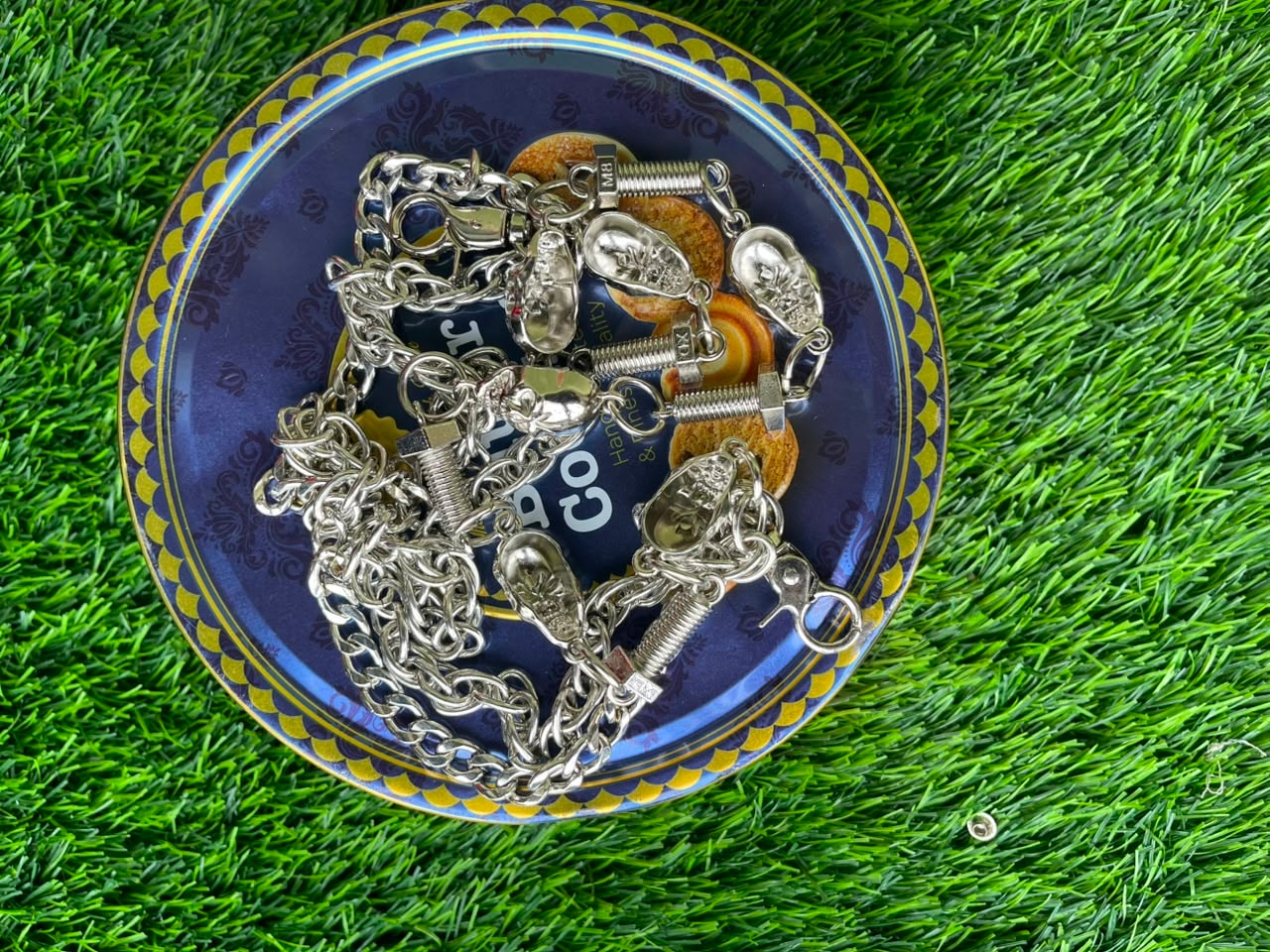 Silver jean chains with skull charms, springs and bullet details.