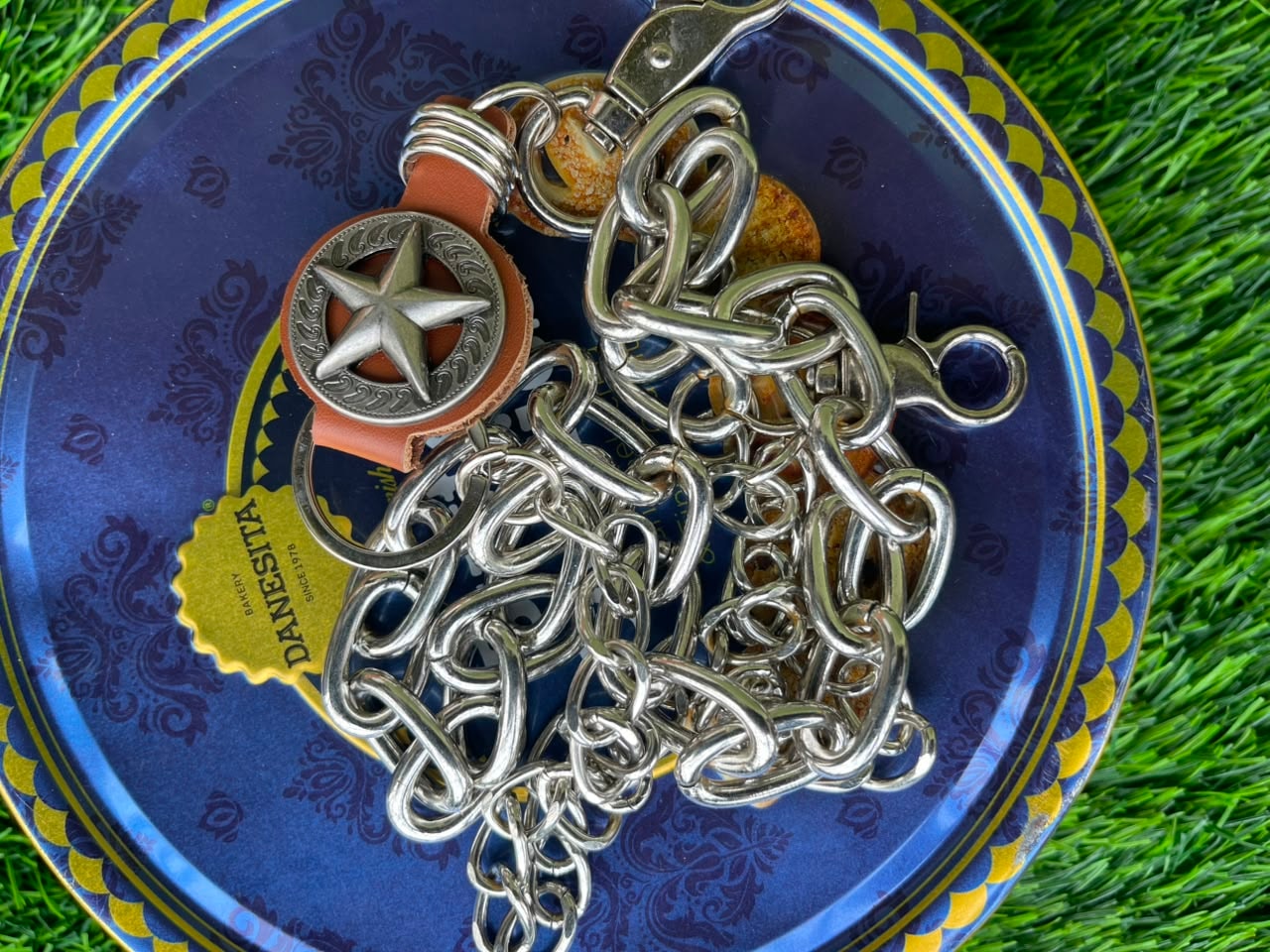 Silver jean chain with brown leather strap and star concho pendant.