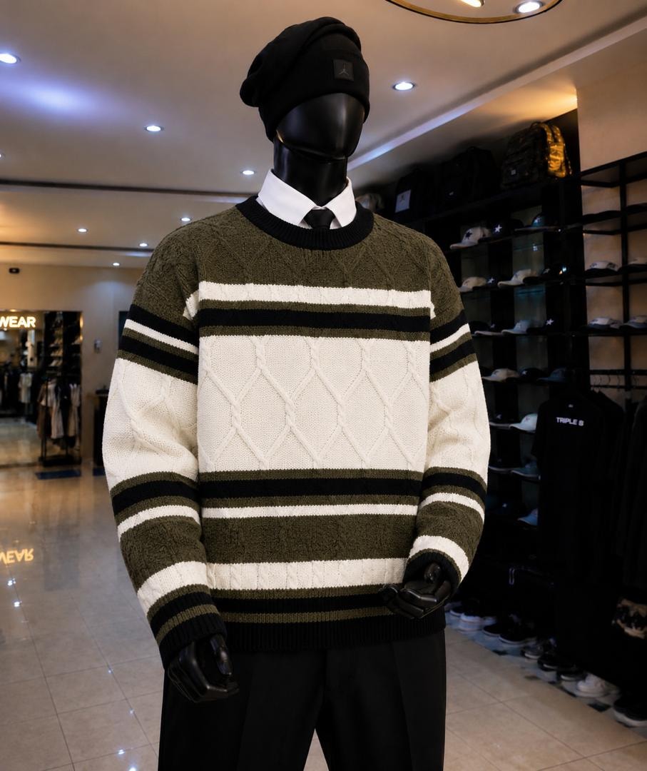 Mannequin wearing olive green white and black striped cable knit sweatshirt.