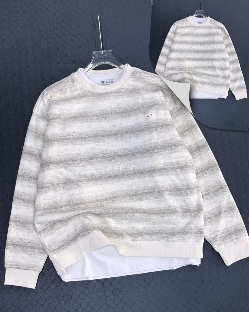 Gray and white horizontally striped long sleeve sweatshirt with small chest label, alternate front view.