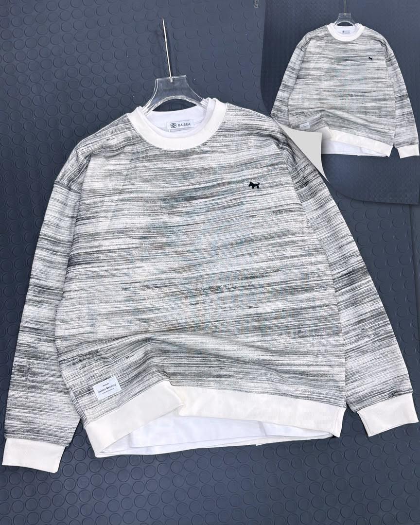 Marbled green and gray long sleeve sweatshirt with small logo on chest, front view on hanger.