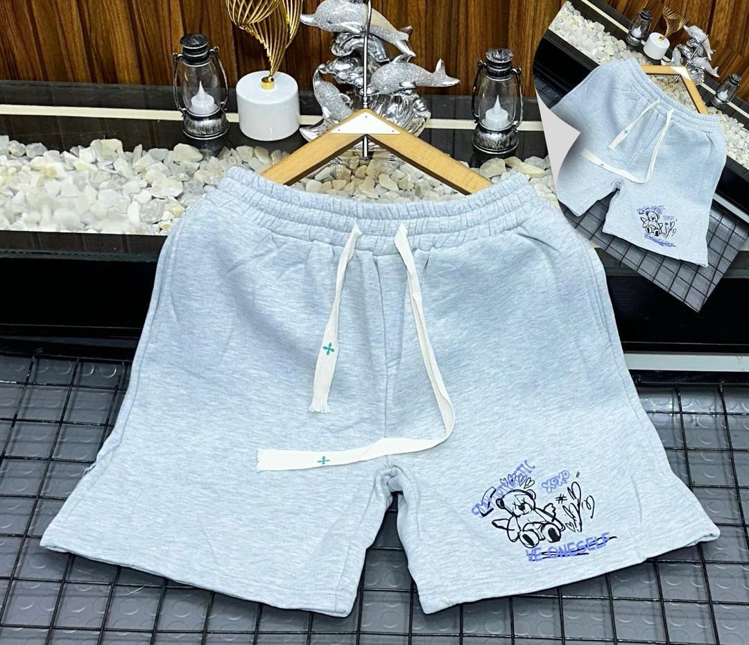 Light blue fleece shorts with teddy bear graphic and STAY AUTHENTIC text.