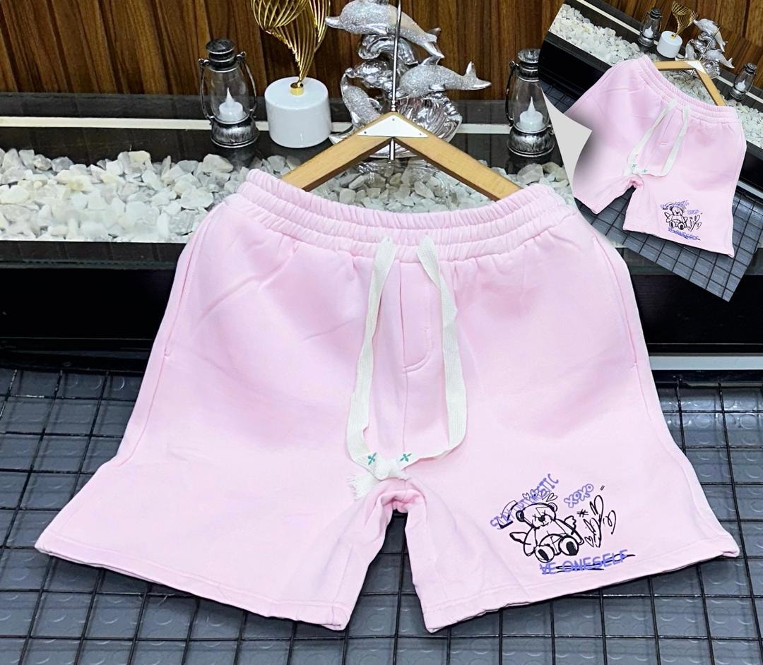 Pink fleece shorts with teddy bear graphic and STAY AUTHENTIC text.