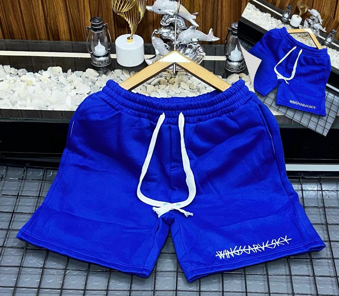 Blue fleece shorts with white drawstring and WINGSCARVSKY embroidery on hem.