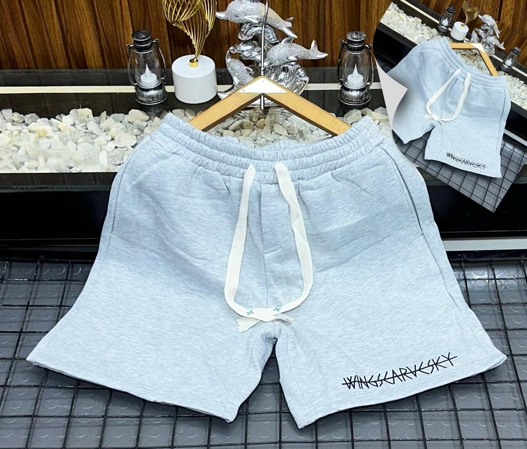 Light blue fleece shorts with white drawstring and WINGSCARVSKY embroidery on hem.
