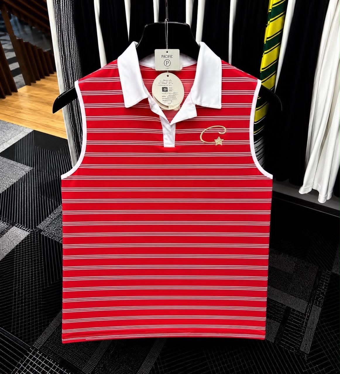 Red striped sleeveless polo top with white collar and gold embroidered logo.