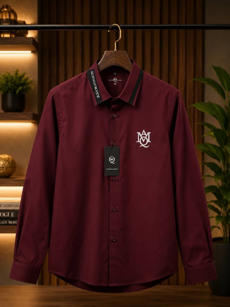 Burgundy Alexander McQueen logo embroidered shirt on wooden hanger.
