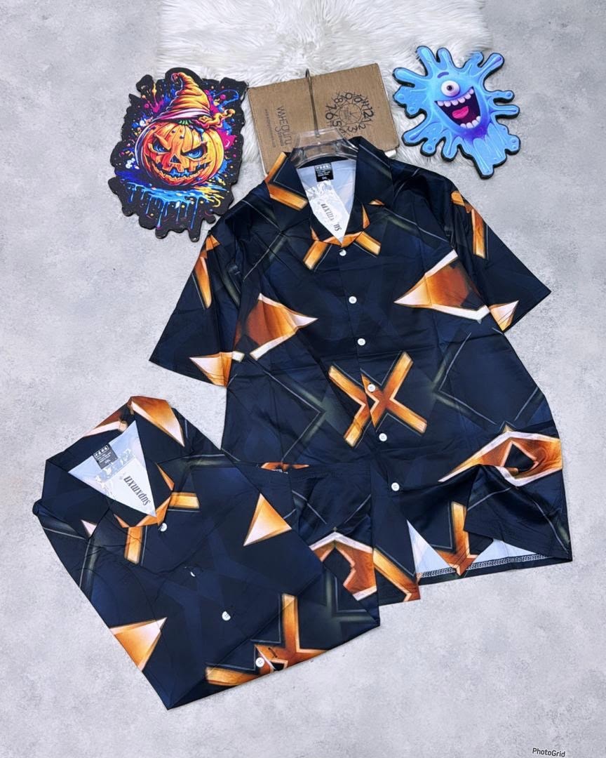Navy short sleeve shirt with orange geometric triangle and X patterns.