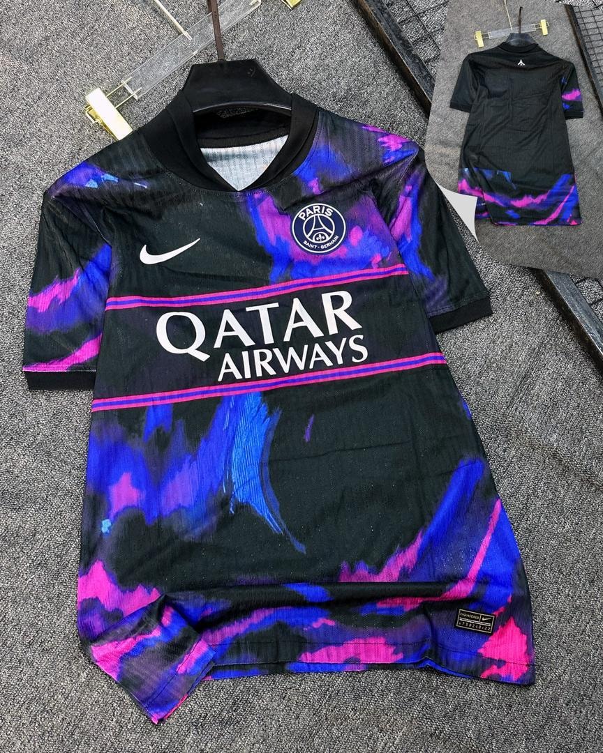 Black PSG soccer jersey with pink blue abstract patterns and club crest.