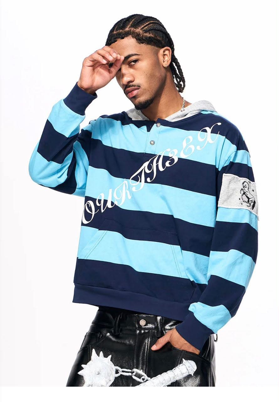 Man in blue striped hoodie posing with hand on forehead.
