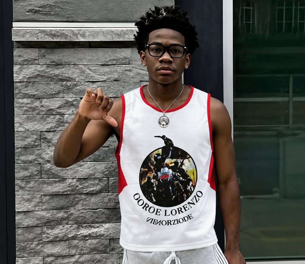 Man modeling white armless tank with red side panels and circular motorcycle graphic.
