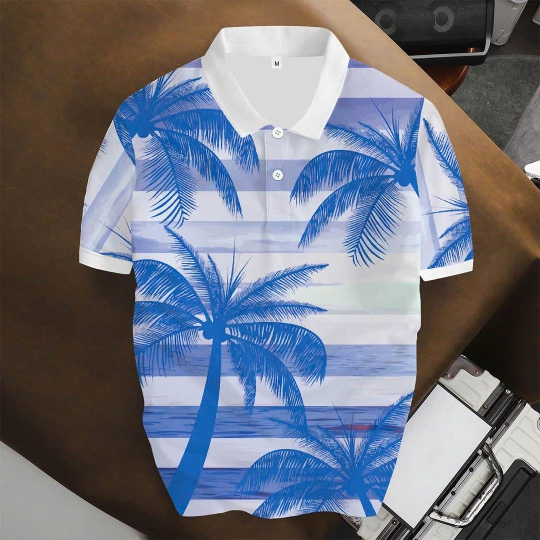White unisex polo shirt with blue palm tree and ocean stripe print, flat lay view.