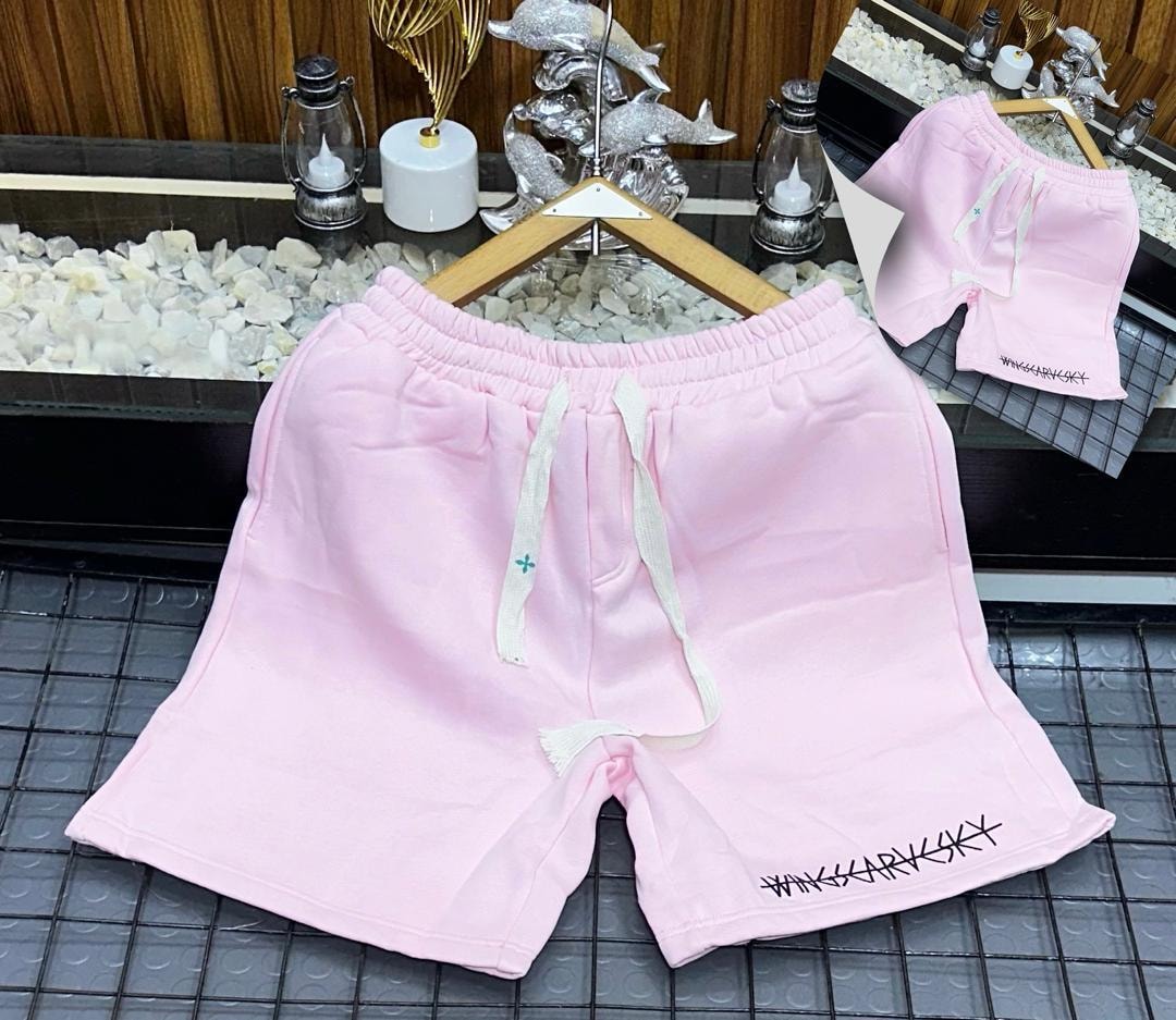 Pink fleece shorts with black embroidered logo on leg.