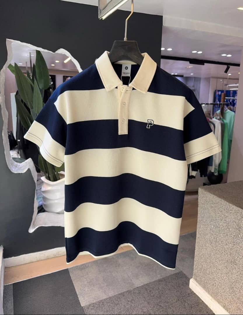 Navy striped polo shirt with cream accents and embroidered P logo.