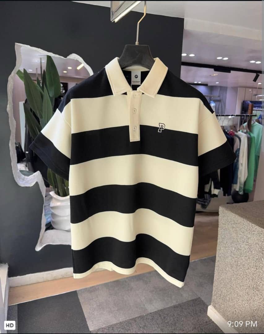 Black striped polo shirt with cream accents and embroidered P logo.