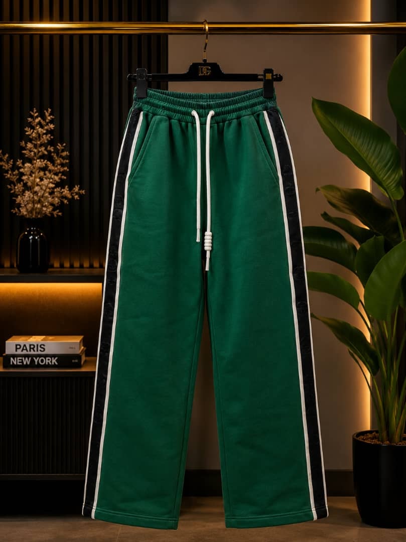 Green joggers with black and white side stripes.
