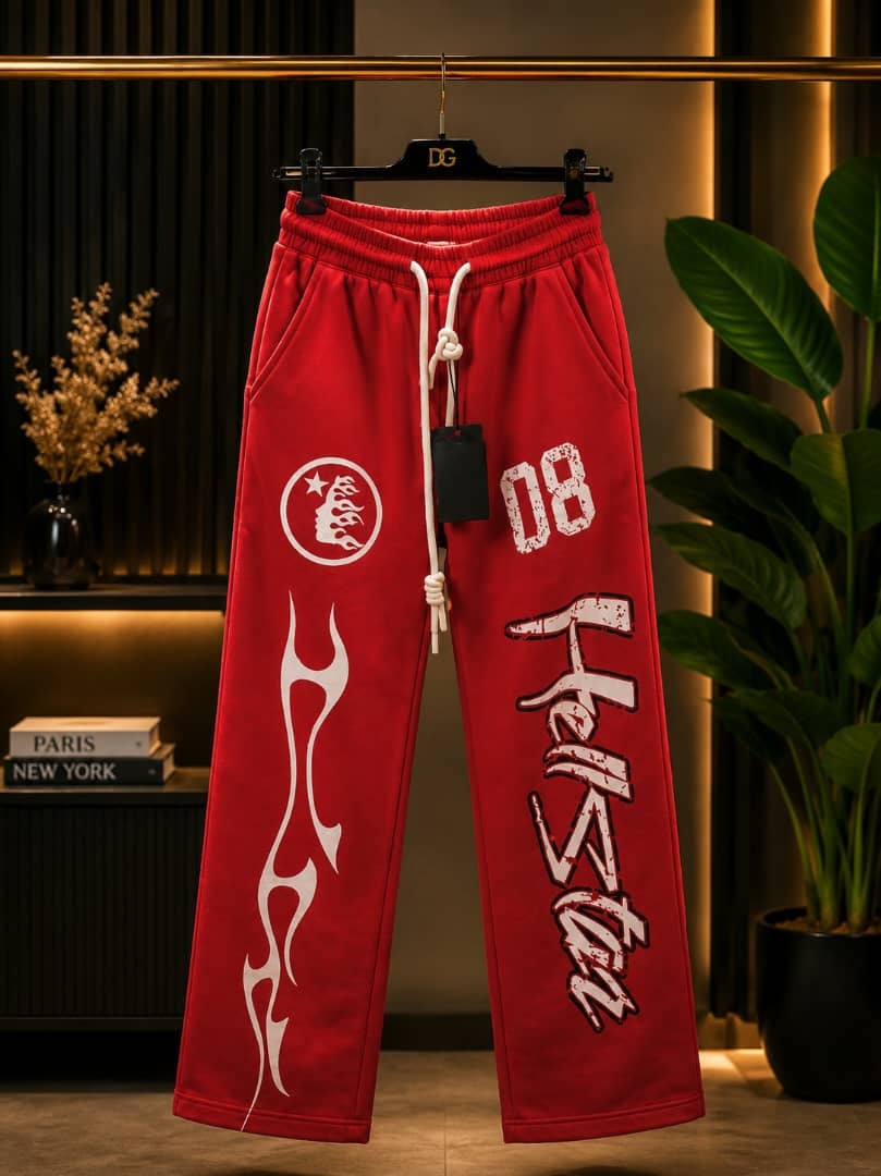 Red joggers with white flame graphics, circular logo and Hellstar text print on the leg.