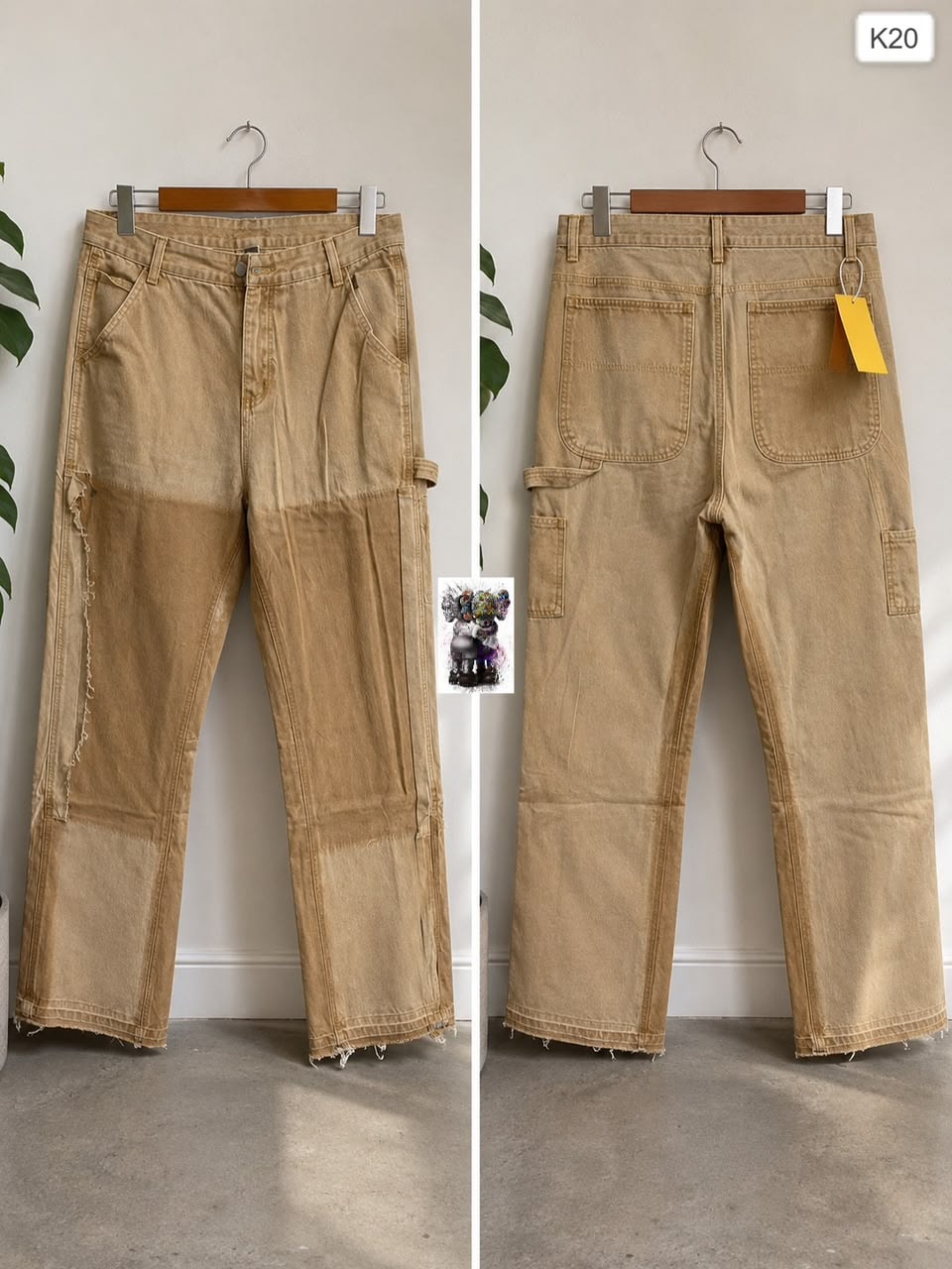 Tan cargo baggy jeans shown in front and back views hanging on wooden hanger.