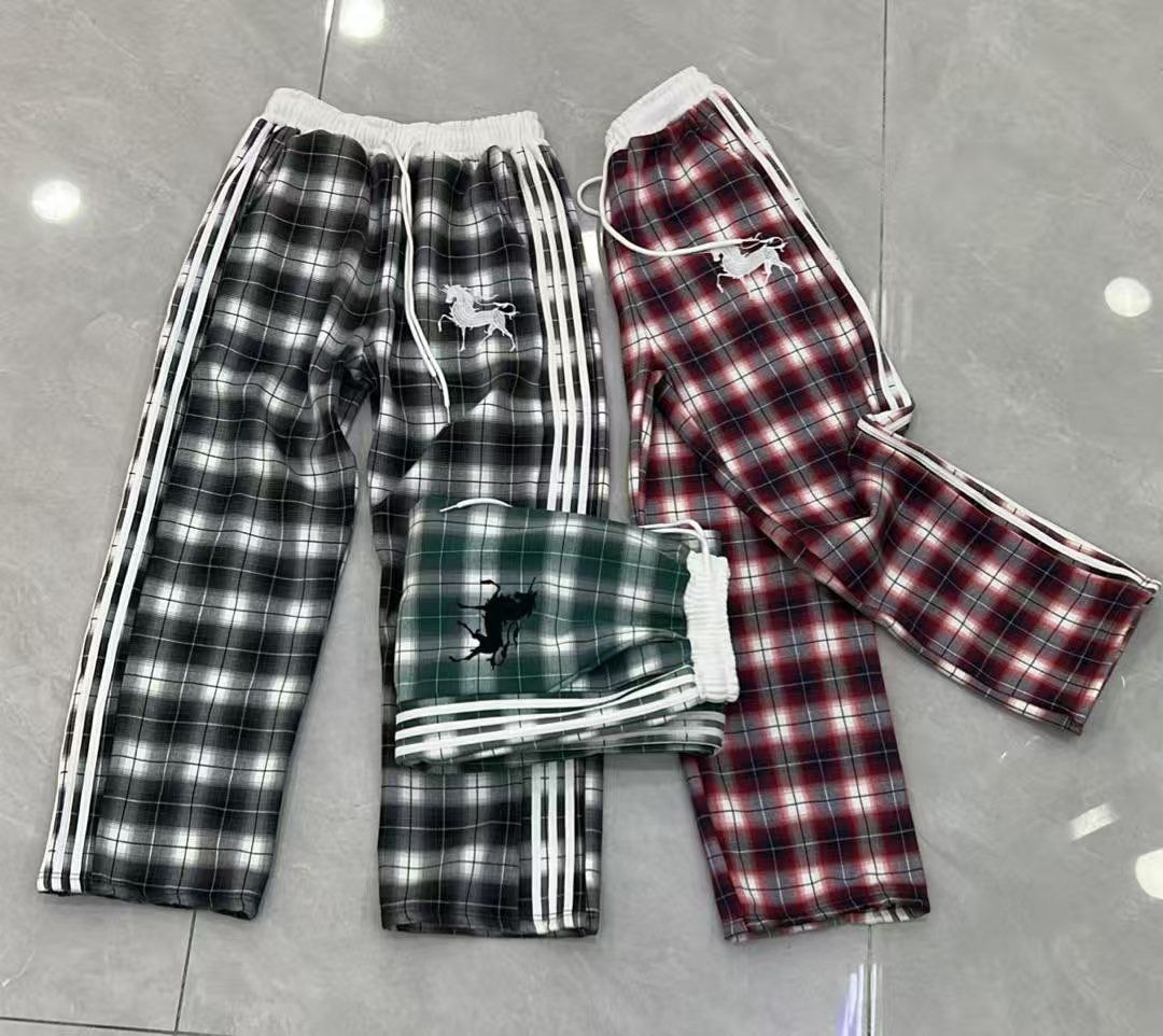 Plaid joggers with horse logo embroidery in black, red, and green colorways.