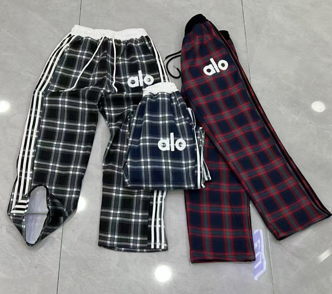 Plaid Alo logo joggers in black, navy, and red colorways with side stripes.