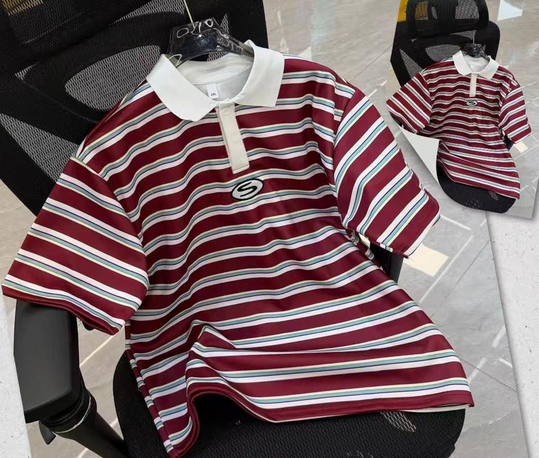 Burgundy wavy striped polo shirt with white collar and S logo on black chair.