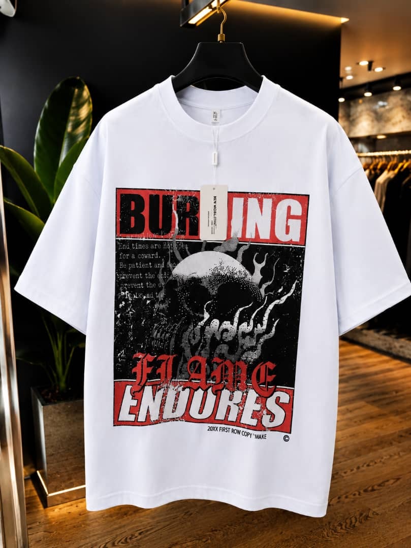 White oversized t-shirt with burning flame endures skull graphic print.
