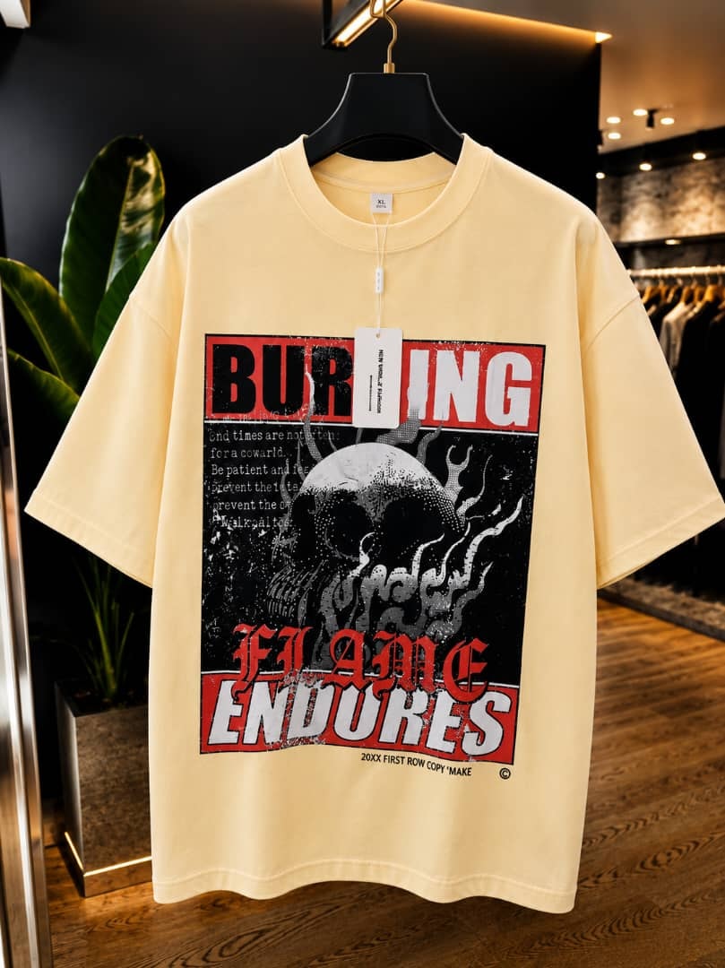Cream oversized t-shirt with burning flame endures skull graphic print.