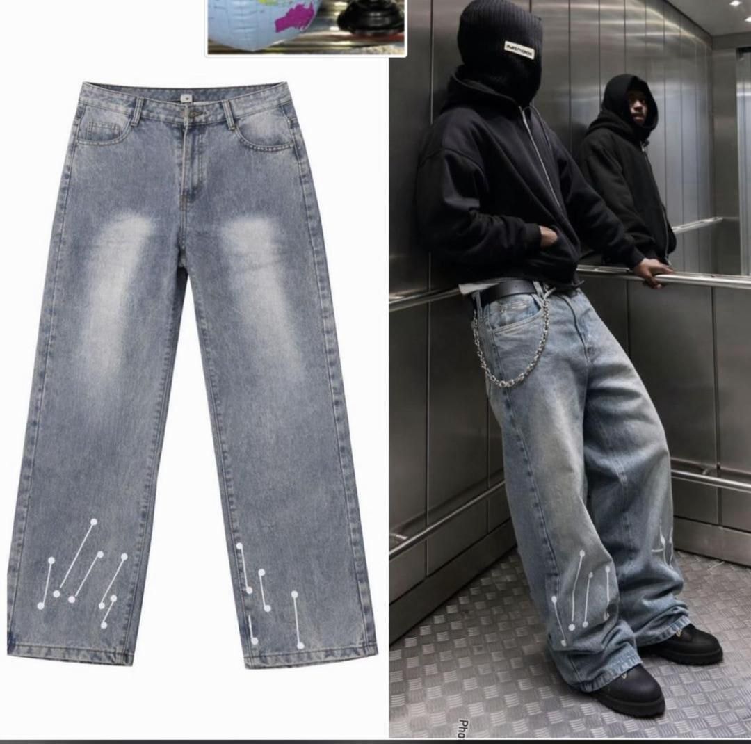 Light blue baggy jeans with white dot patterns shown in flat lay and on model in elevator.
