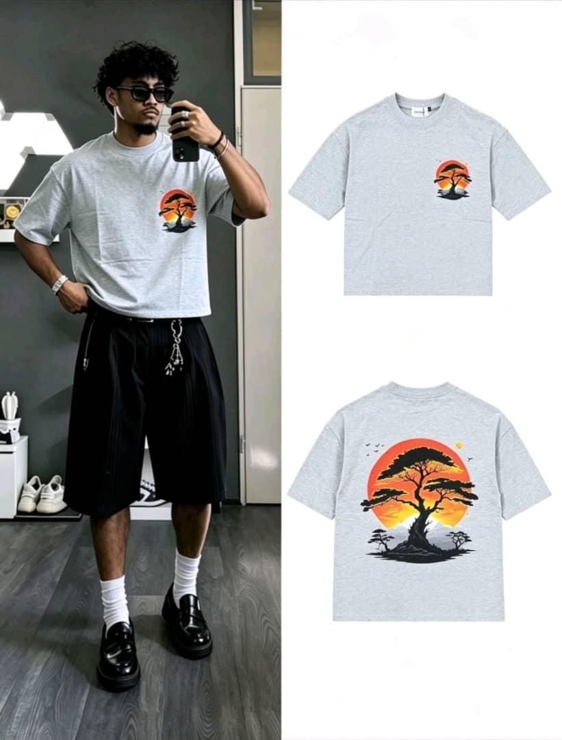 Man wearing gray sunset tree graphic t-shirt with flat lay of back design.