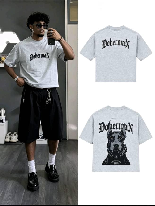 Man wearing gray Doberman graphic t-shirt with corresponding back print flat lays.