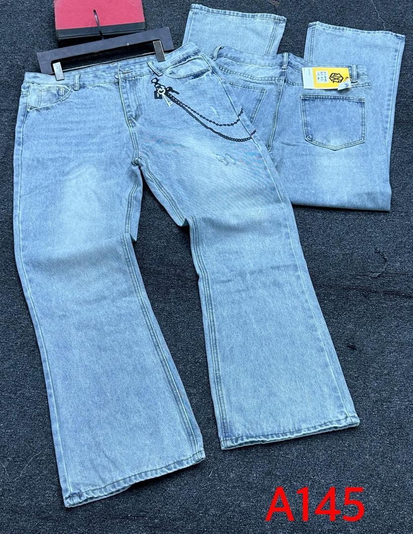 Light blue baggy jeans with chain on back pocket and subtle distressing laid flat.
