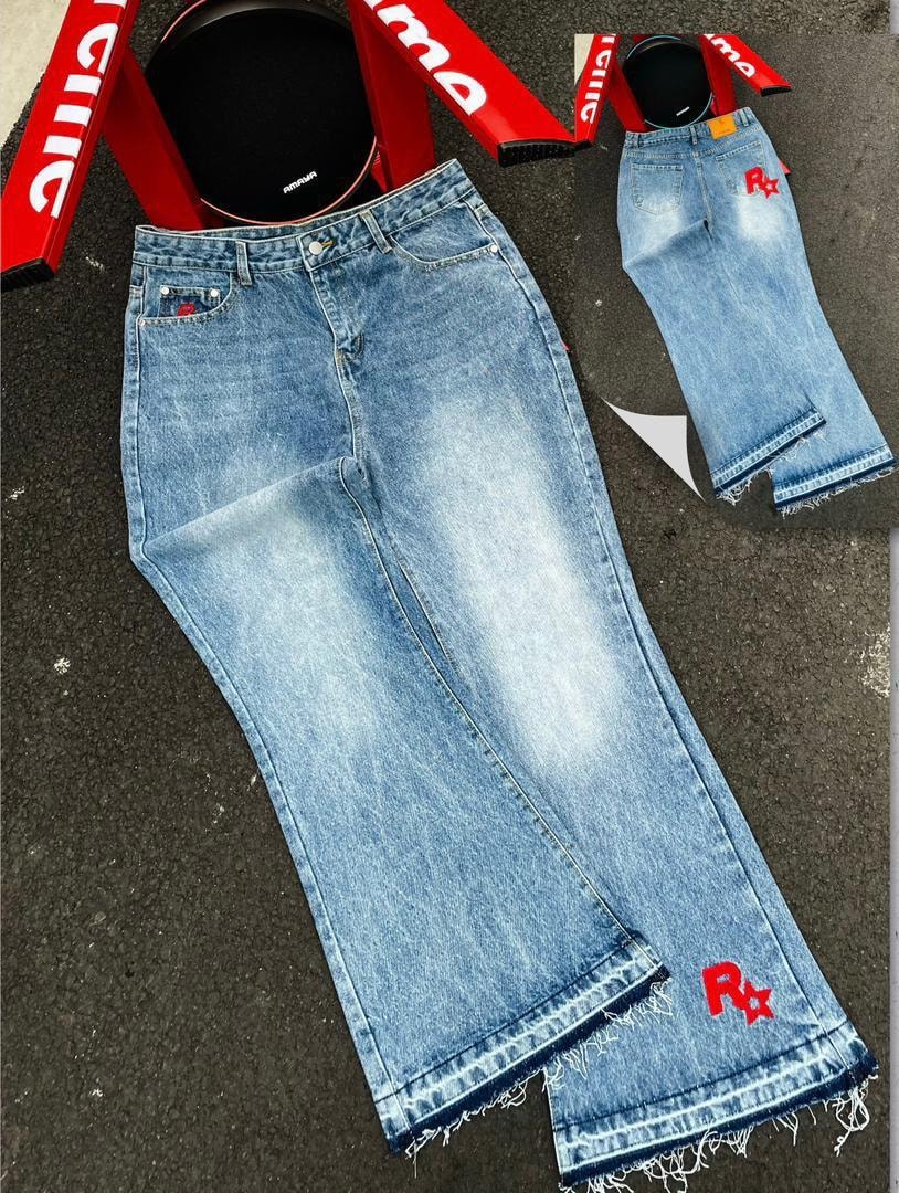 Flat lay of light blue baggy jeans with red R* graphics on leg and pocket plus inset back view.