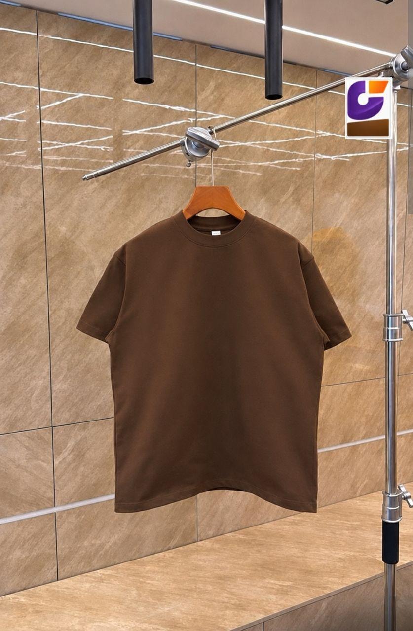 Brown plain unisex crew neck t-shirt on wooden hanger against tiled background.