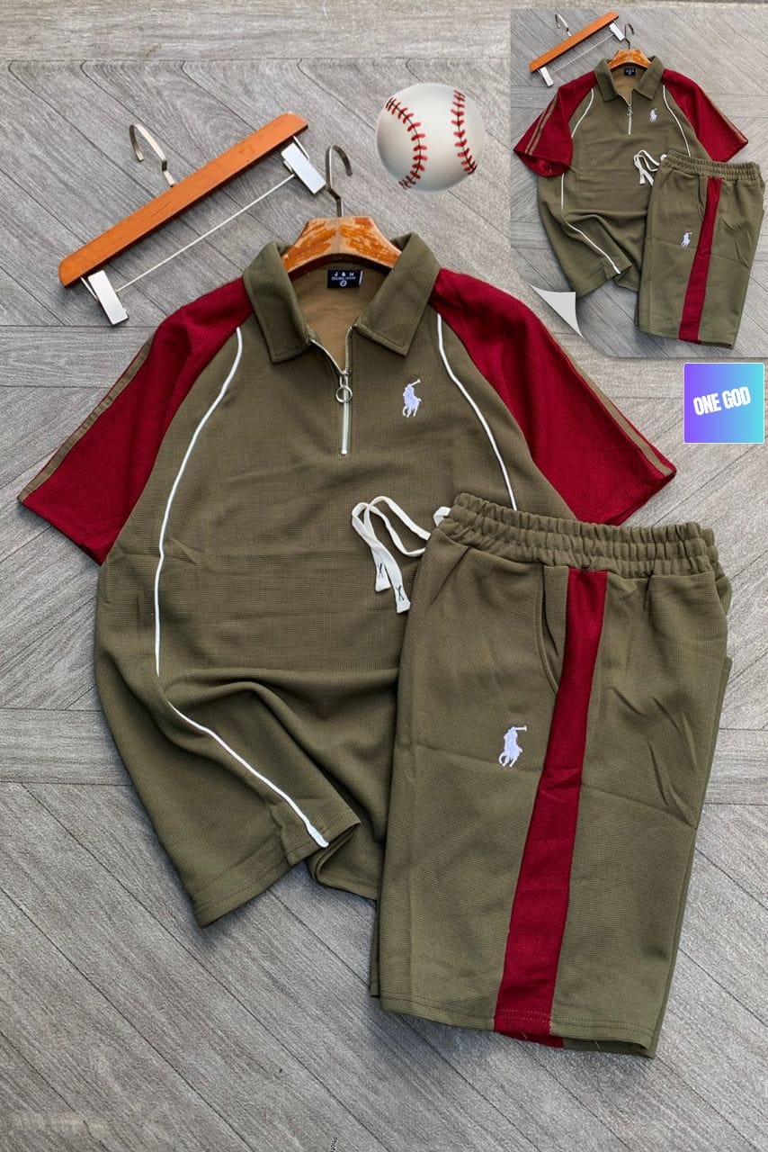 Olive polo two-piece set with red contrast sleeves and shorts on gray floor.