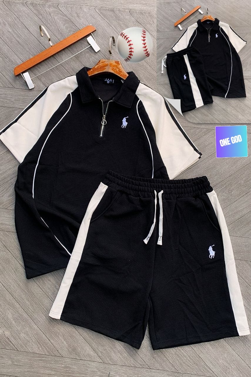 Black polo two-piece set with white contrast sleeves and shorts on wooden floor with props.