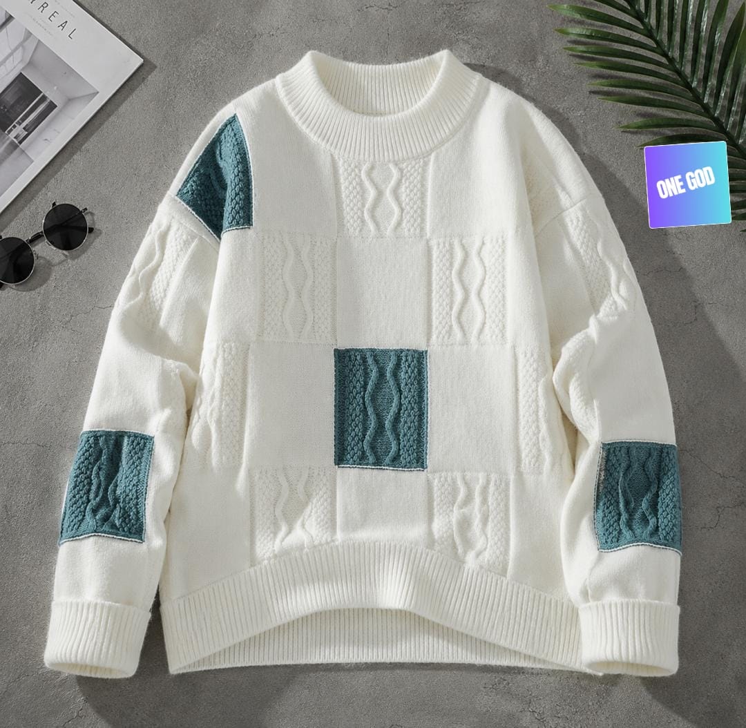 White sweater with teal cable knit panels on body and sleeves.