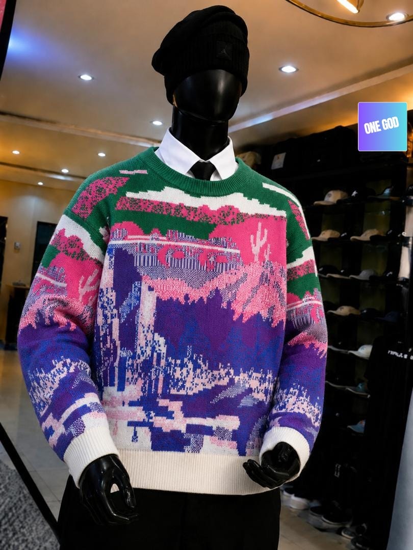 Multicolor pixel art landscape knit sweater in green pink purple on mannequin.