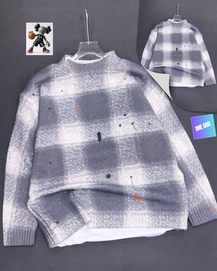 Gray plaid sweatshirt with paint splatters on hanger showing back view.