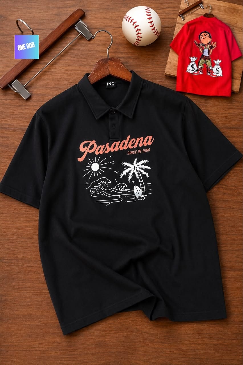 Black polo shirt with Pasadena graphic print, sun, palm and wave design on wooden surface.