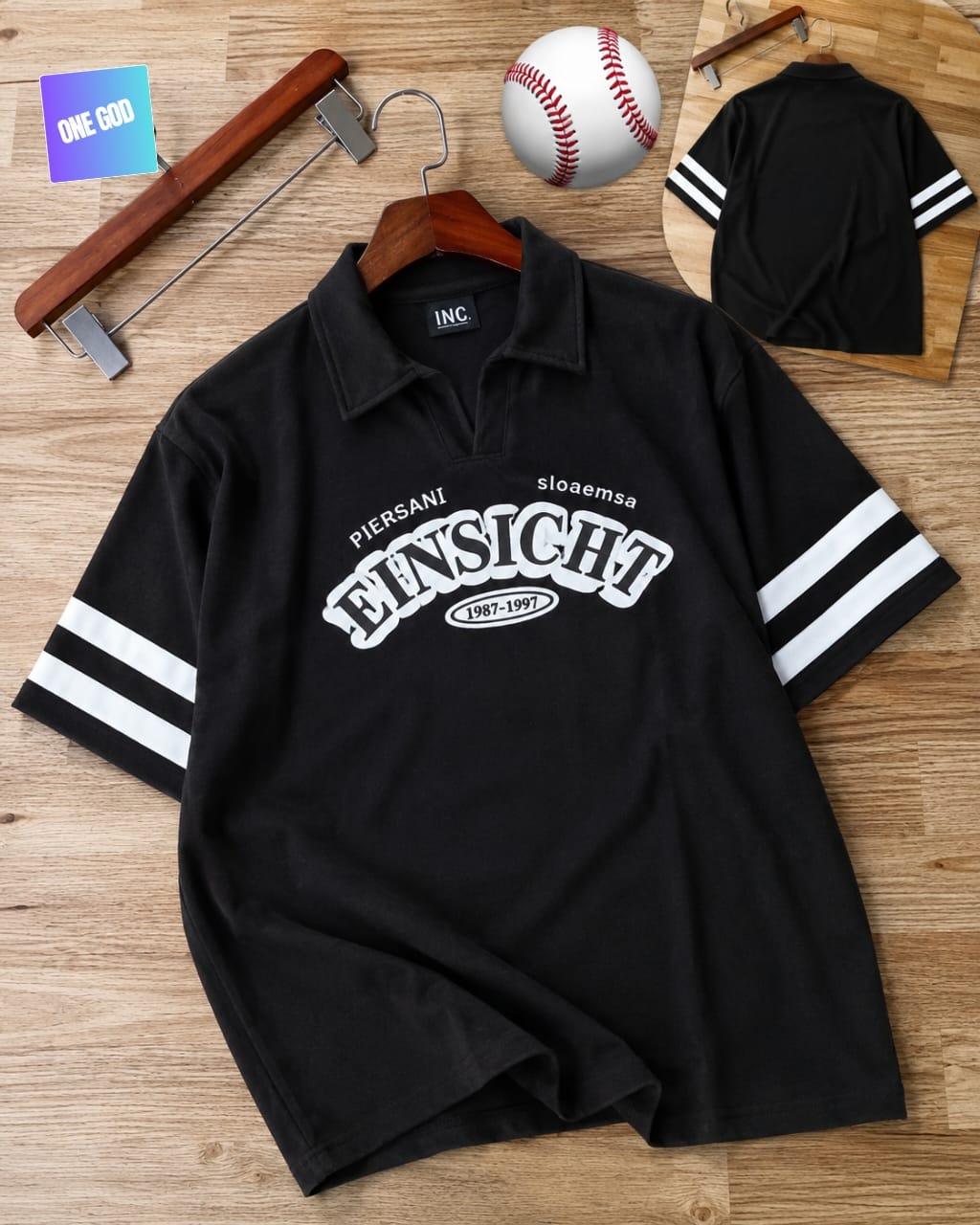 Black polo shirt with white striped sleeves and large Einsicht text graphic on chest.