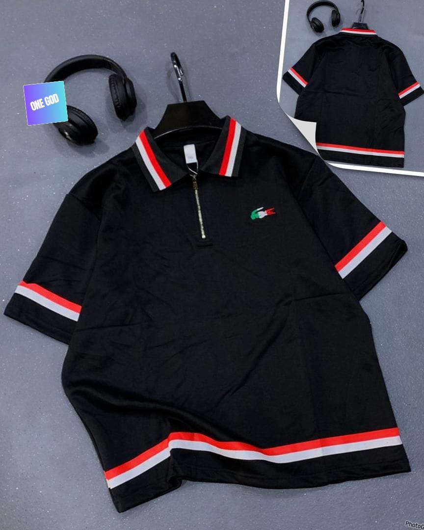 Black polo shirt with zip collar, crocodile embroidery and red white striped sleeves.