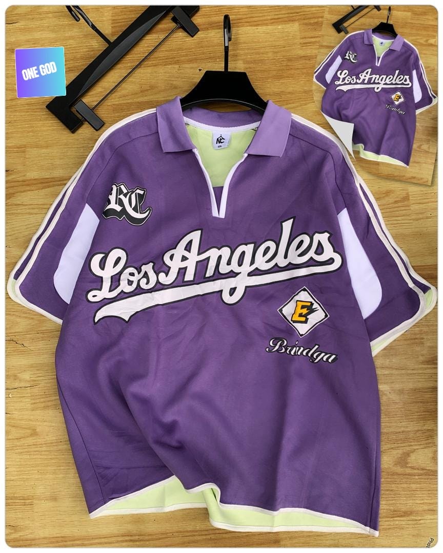 Purple polo shirt with Los Angeles script, KC logo and E diamond emblem.