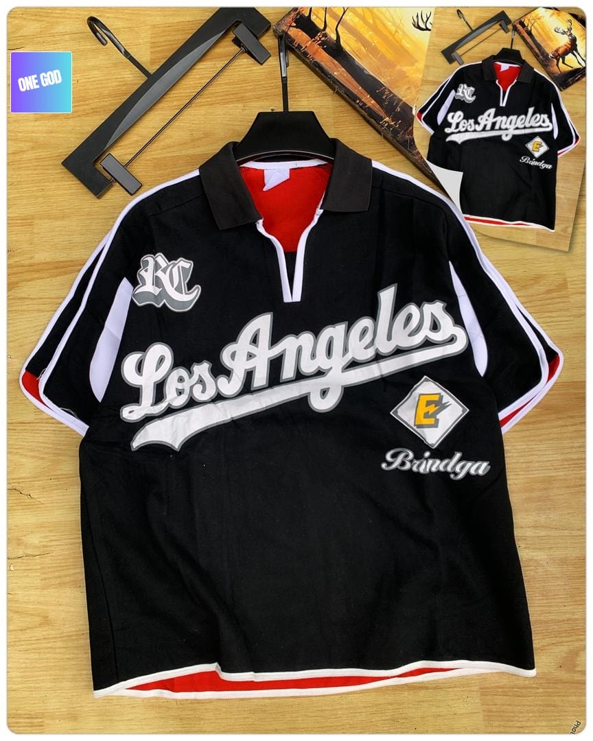 Black polo shirt with Los Angeles script, KC logo and E diamond emblem.