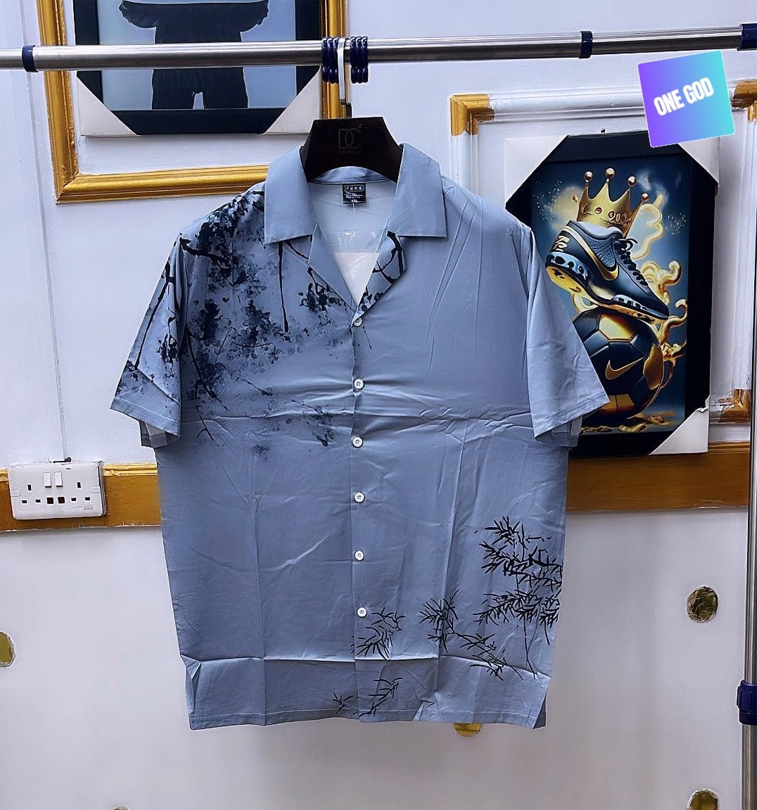 Light blue short sleeve button-up shirt with black splatter and bamboo prints.