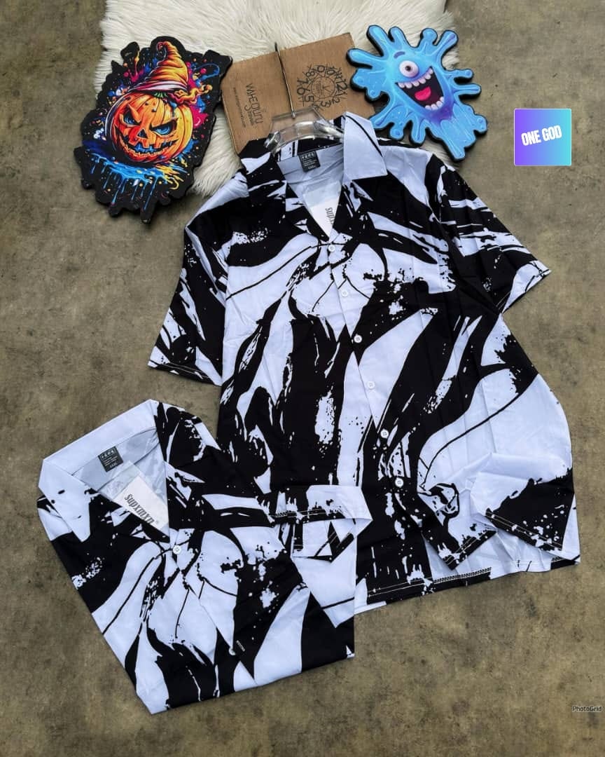 Short sleeve shirt with black and white abstract graphic print, shown hanging and folded.