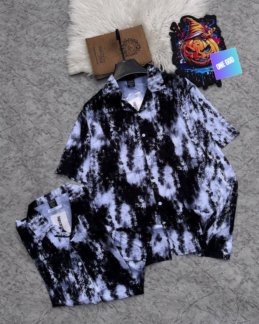 Short sleeve shirt with black and white splatter and cloud tie-dye effect.