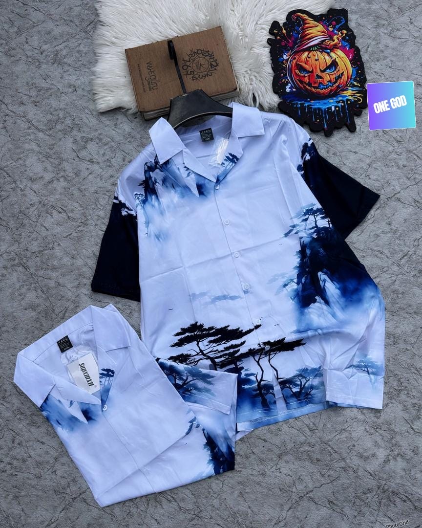 White short sleeve shirt featuring blue and black tree and mountain landscape print.