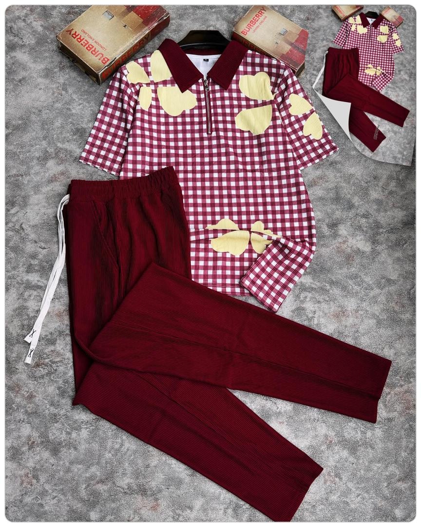 Red and white gingham polo with yellow hearts paired with red pants.