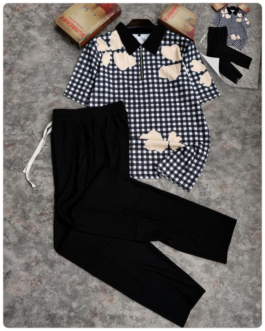 Black and white gingham polo with cream hearts and black ribbed pants.