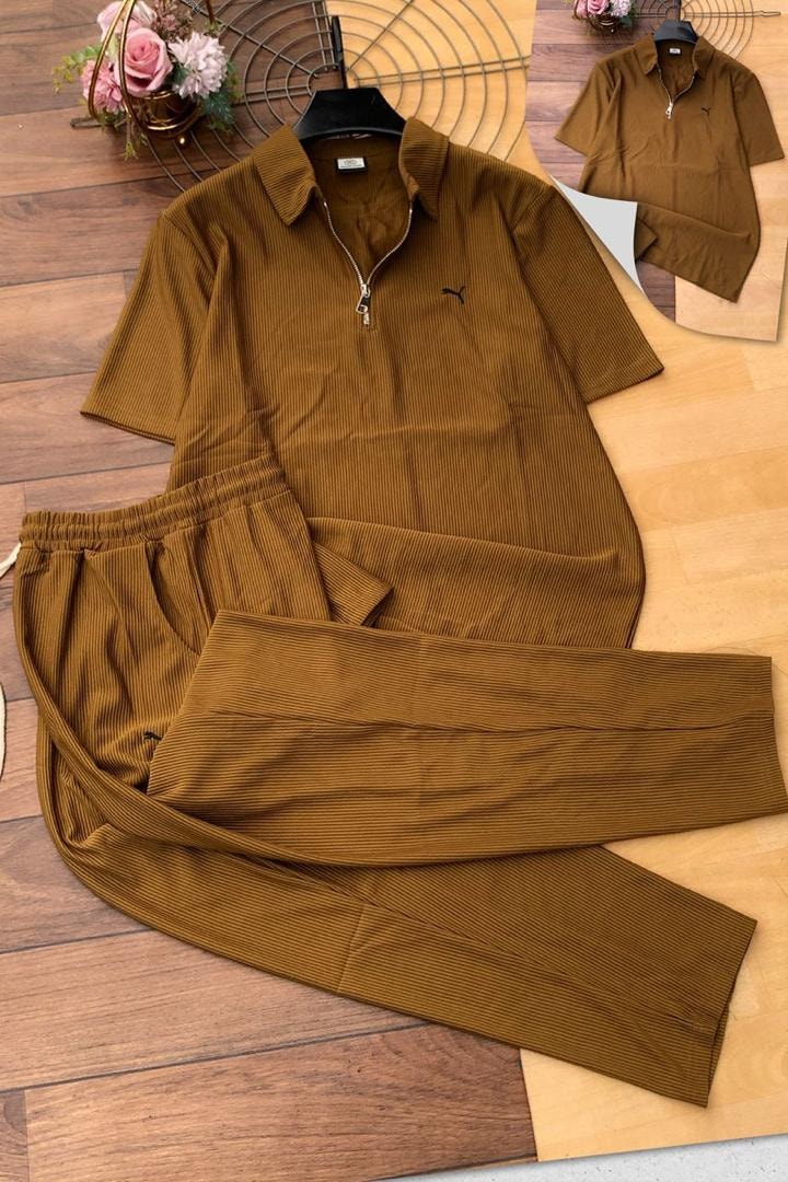 Brown ribbed polo shirt and pants with small Puma logo on chest.